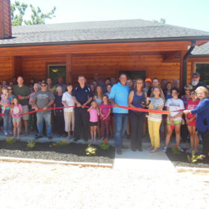Group picture of ribbon cutting ceremony for House of Healing bunkhouse